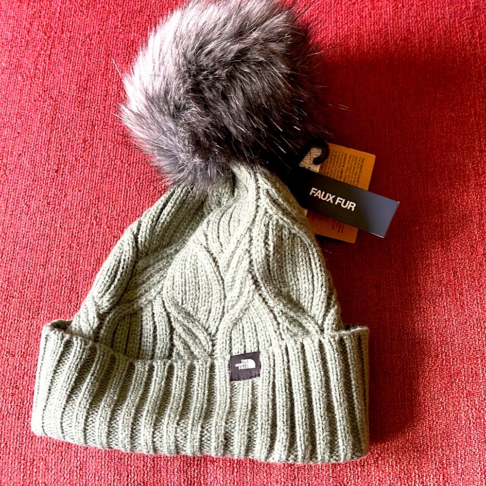Youth North Face hat with large faux fur Pom Pom.